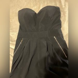 Black jumpsuit with gold zippers